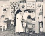 Adrian Dominican Sisters inspecting the sewing of a Home Economics student