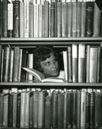 Delaine Chivers reading in the Adrian Hall library stacks