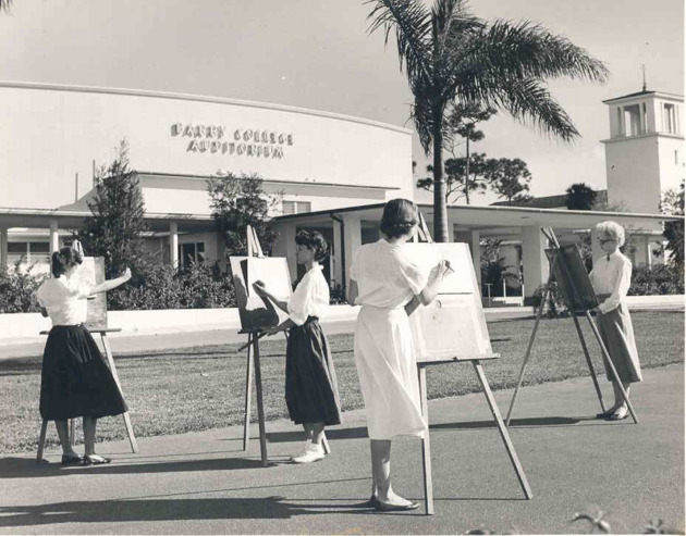 Art students drawing on easels in front of the Barry College Auditorium