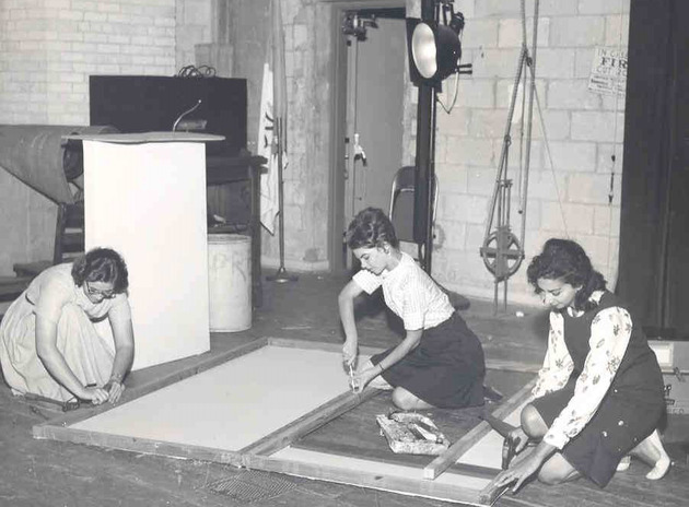 Drama students Patricia Lovarco, Maryanne Mangold, and Lucille Moss construct a stage prop for the theater