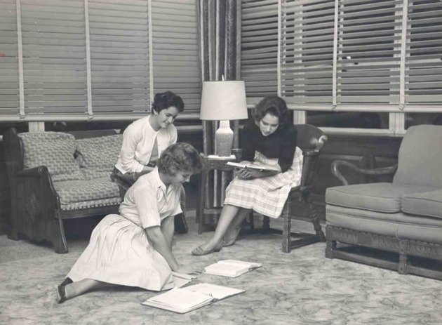Three students studying in the east lounge of Weber Hall
