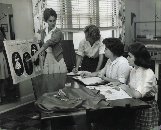 Students in Clothing class discuss design patterns for sewing