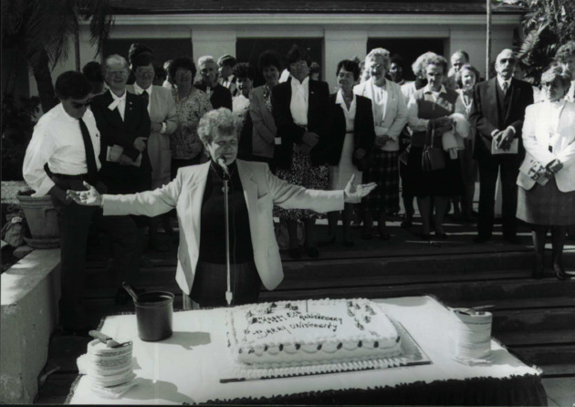President Sister Jeanne O'Laughlin, O.P., and a group of sisters, faculty and staff at the cutting cake ceremony