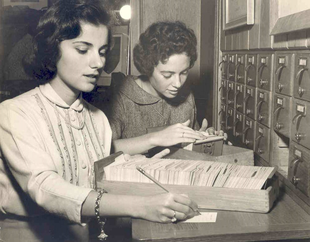 Students using library card catalog