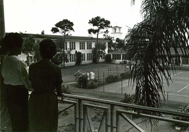Students on Adrian Hall second floor looking toward tennis courts