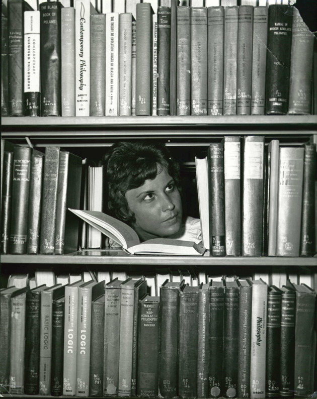 Delaine Chivers reading in the Adrian Hall library stacks