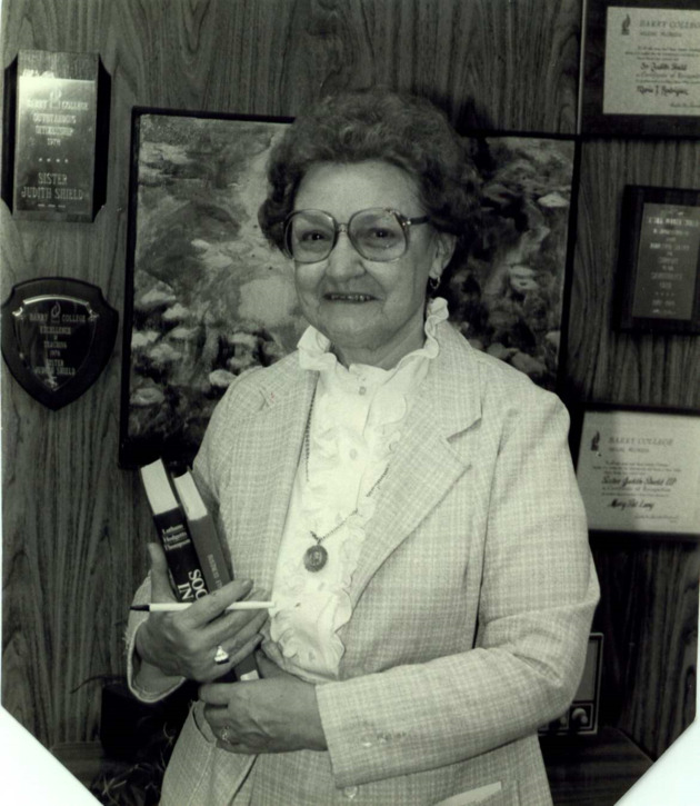 Sister Judith Shield, Associate Professor of Economics, standing in her office