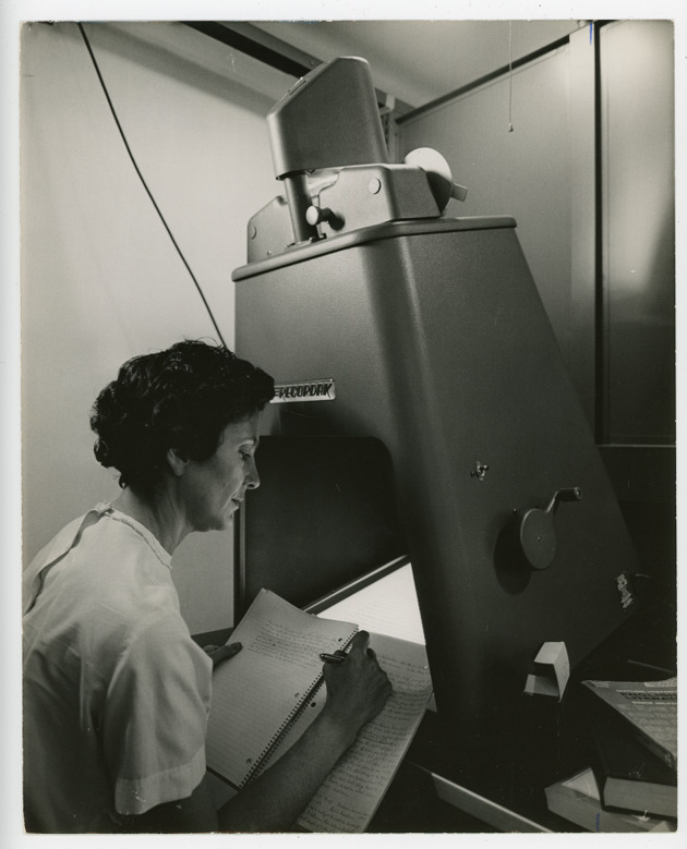 Student doing research work on a Recordak microfilm machine