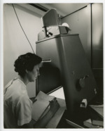 Student doing research work on a Recordak microfilm machine