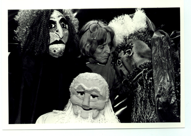 Patricia Minnaugh, Associate Professor of Theatre, poses with puppets