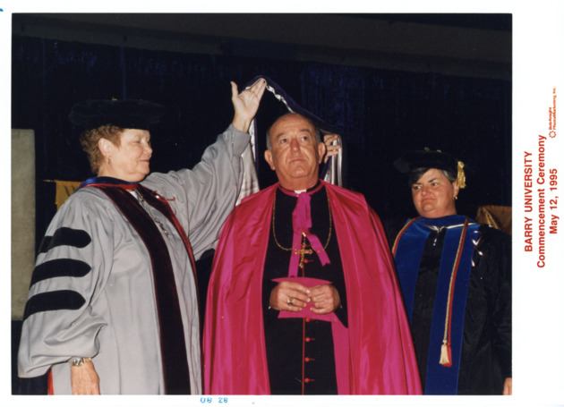 Archbishop Favalora receives the Doctoral hood from Sister Jeanne O'Laughlin and Sister Peggy Albert