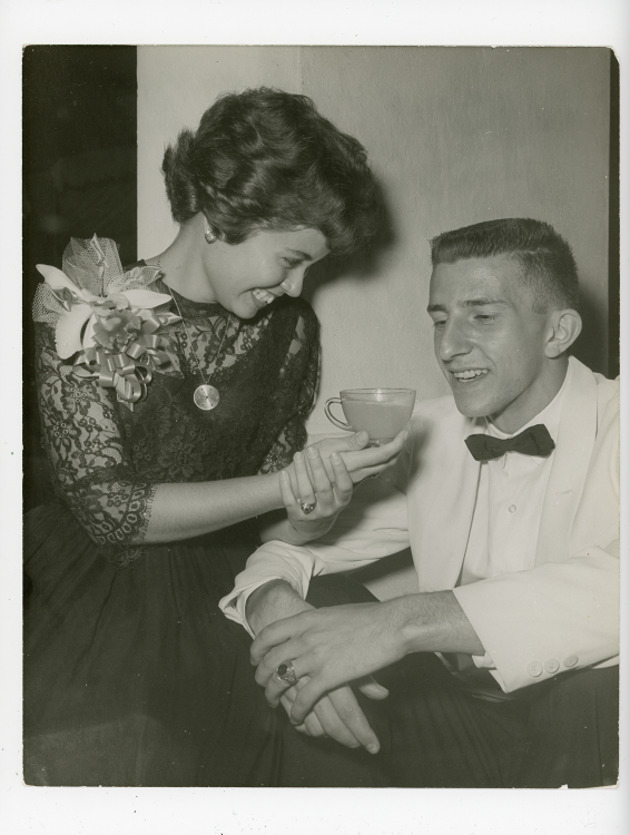 Mary Graham shares a drink with a friend at the Coronation Ball, 1962
