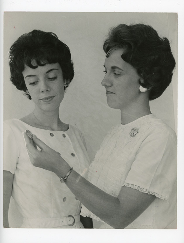 Student Margie Raible giving a Presidential Prayer Corps pin to a classmate