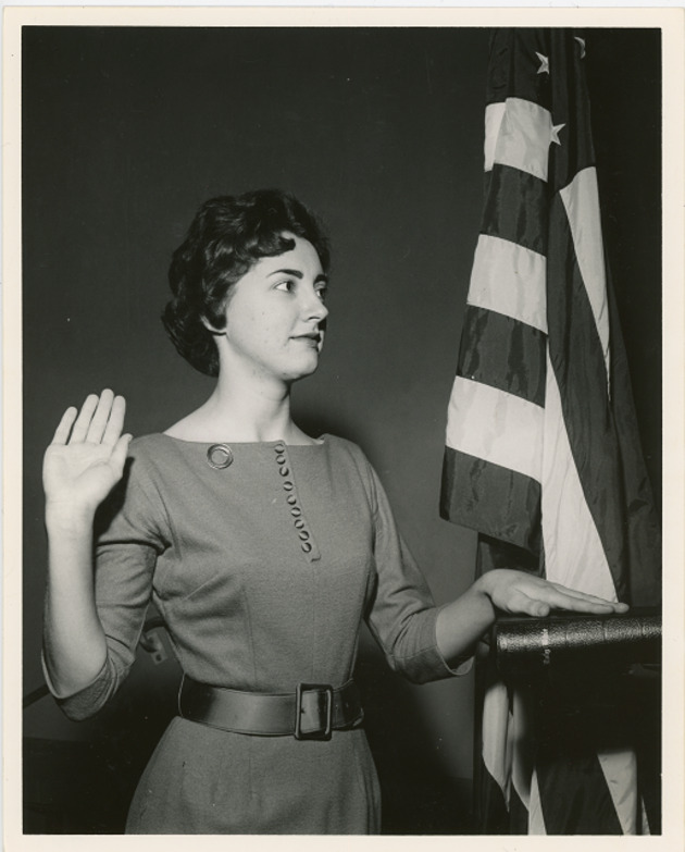 Student taking an oath of allegiance with her hand on the Bible